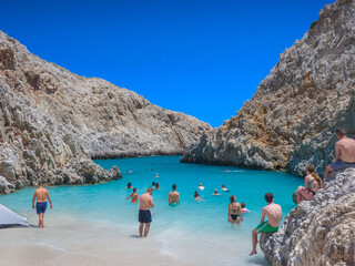 Beach with clear water between cliffs (Seitan Limania, Crete, Greece) - obrazy, fototapety, plakaty