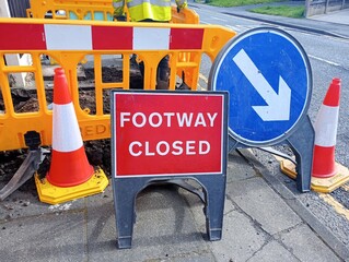 Footway closed sign in front of barrier with white arrow sign.  19-04-2024, Lancashire, UK - 788888909