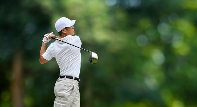 Golfer hit sweeping driver after hitting golf ball down the fairway.