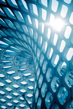 Abstract structure of modern architecture made of glass and metal in a Chinese city, the sun's rays