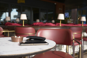 forget smartphone and a wallet on cafe table 
