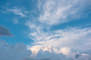 Scenic view to clouds illuminated by sunset in blue sky. Nature background of cloudy sky in...
