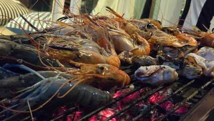 Grilled shrimp on a charcoal grill, seafood at the pool villa