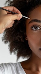 Obraz premium Elegant Morning Makeup Session: Skilled Artist Applying Clean Makeup on Young Model in Minimalist Studio