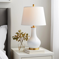 White table lamp and books on the table near the window and bed