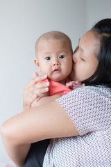 Asian mother holding her infant girl