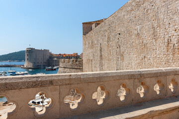 View from within old town with characteristic rosette shaped opening in wall to bay and boats turret.