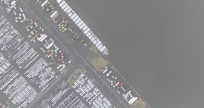 Aerial top down view on roll on roll off terminal, shipping and logistics of vehicles over the world. Top down view on ship docked and loaded in the port. Zeebrugge, Belgium.