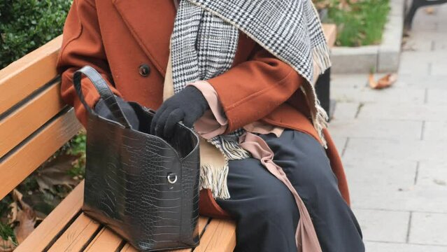 women looking for something in her purse