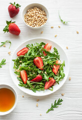 Fresh Strawberry Arugula Salad With Pine Nuts Served on a Bright Day