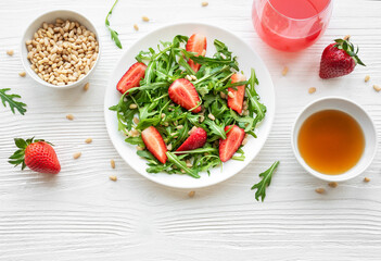 Fresh Strawberry Arugula Salad With Pine Nuts Served on a Bright Day