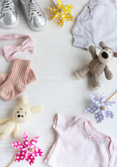Baby clothes with knitted toys dog and rabbit, toy windmills and baby shoes and accessories.