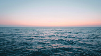 Obraz premium Minimalist sunrise over a calm ocean with a subtle gradient sky and a hint of light on the water