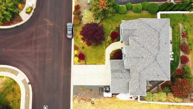 Aerial: Drone Top Panning Shot Of Cars Parked Outside Roofed Houses - Rural, Idaho