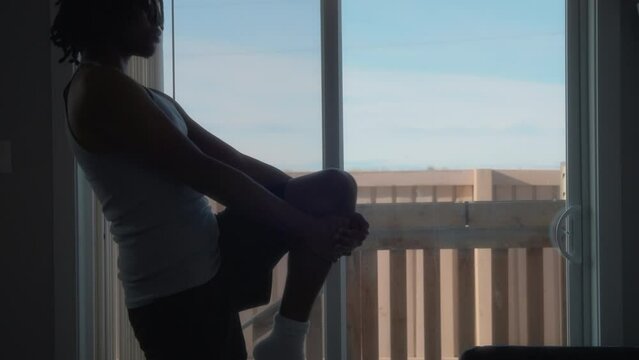 Young Athletic Man Stretching In Front Of A Window At Home. Healthy Lifestyle And Sport. Slow Motion. 