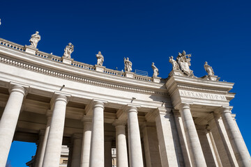Detail of St. Peter's Square Doric colonnades, framing the trapezoidal entrance to the basilica and...