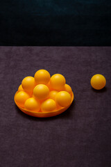 Orange balls in a plate on the table