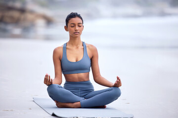Calm woman, yoga and beach mediation with lotus pose for wellness, zen mindset and spiritual...