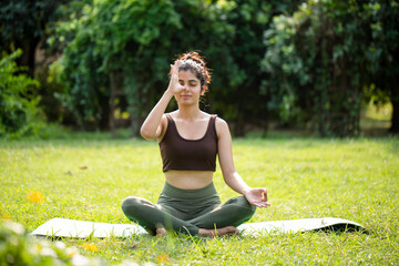 Ravishing Woman Doing Anulom Vilom Pranayama In Park
