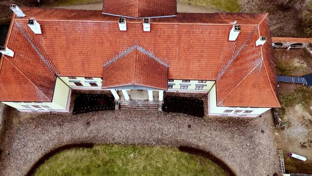 Neoclassical Durbe Manor House In Tukums, Latvia. aerial tilt-up, pullback shot