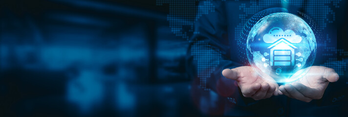 Businessman holds a global data warehousing globe with a network connected to various industries and markets. Leveraging advanced data warehousing technology to drive business development.