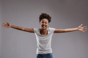 Smiling woman in white, arms outstretched wide