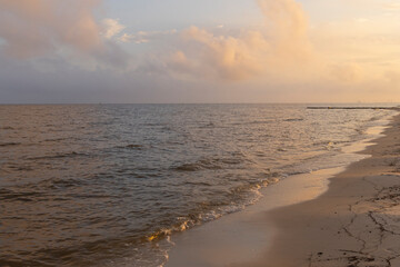 A scenic sunset view of a beach on the Gulf of Mexico in Biloxi, Mississippi, United States of...