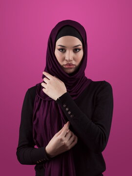 Modern Muslim woman wearing stylish hijab casual wear isolated on pink background. Diverse people model hijab fashion concept.