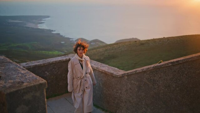 Woman walking stairs sunset coastline enjoying nature beauty. Lady posing coast 