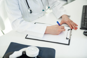 Dedicated healthcare professional recording patient notes during a busy workday