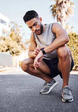 Smart watch, fitness and man on road to check health app, heart rate or exercise progress for body wellness. Sport, clock or runner on digital tech for pulse, training or monitor workout time outdoor
