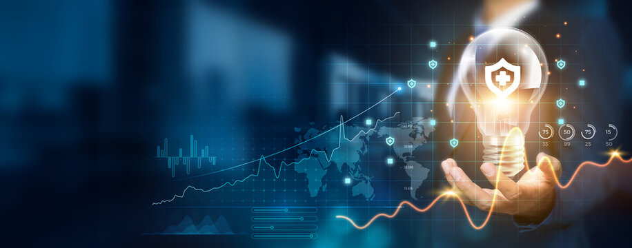 Businessman holding creative light bulb with growth graph and insurance technology icons. Embracing insurance technology to develop new strategies and solutions that enhance success.