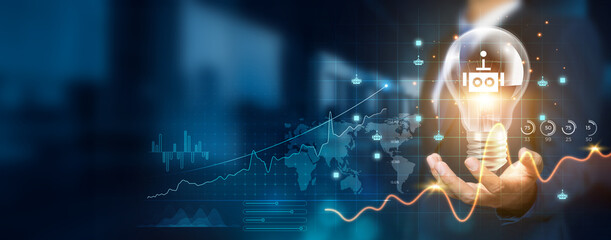 Businessman holding creative light bulb with growth graph, robotics icons. Embracing innovation technology to develop new strategies and solutions that enhance successful and profit in global business