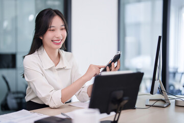 Investor businesswoman using calculator to calculation statistics stock while checking data on tablet to working about stock and marketing of new startup to analysis trade and investment of business