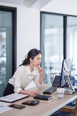 Investor businesswoman standing and reading business stock data on computer while working about stock and marketing of new startup to analysis trade and investment of business project in office - 788990994