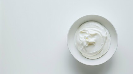 Fototapeta premium Bowl of white creamy yogurt isolated on white background top view flat lay : Generative AI