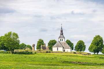 Church with a abbey ruin on a hill in Sweden - 789005950