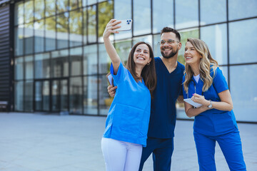 Doctors, team and selfie with diversity and health group, happiness with collaboration and smartphone photography. Medical professional, happy in picture and people in medicine with peace hand sign - 789005958