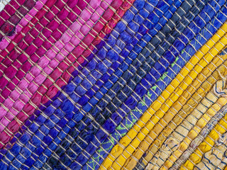 Detail of stitched fabric on a colorful rag rug