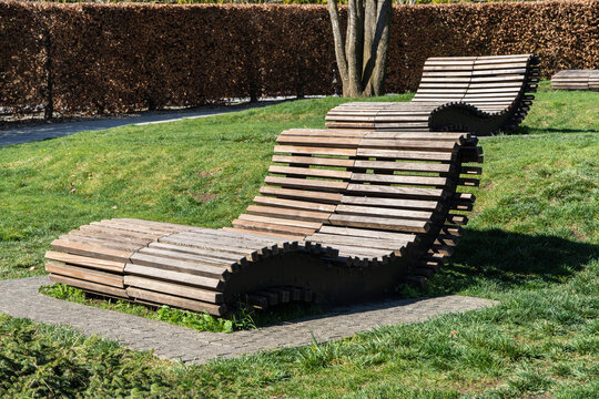 Public landscaped city park of Krasnodar or &ldquo;Galitsky Park&rdquo; for relaxation and walks. People relax on Comfortable benches for rest are installed in shade of deciduous trees. Sunny spring 2024