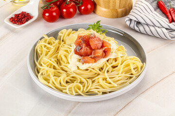 Pasta spaghetti with salmon and stracciatella