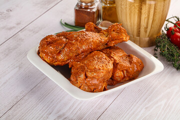 Raw turkey shoulder wing in Indian tandoori marinade