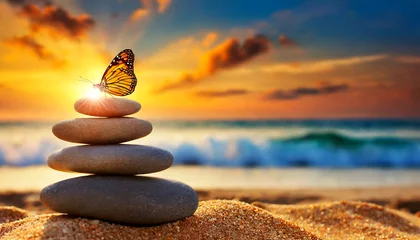 Tuinposter Balance of Zen stones and a butterfly on the sandy beach at sunset or sunrise, close-up, beautiful seascape and sky with clouds and copy space on background. Zen or Feng Shui concept. Generative Ai. © Alberto Masnovo
