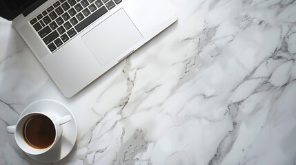White marble office desk table with laptop computer cup of coffee and supplies Top view with copy...
