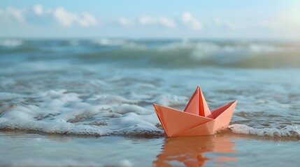 Origami paper in the shape of a boat that is stranded on the beach