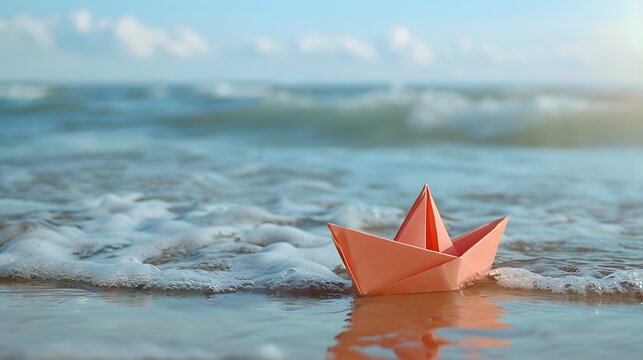 Origami paper in the shape of a boat that is stranded on the beach