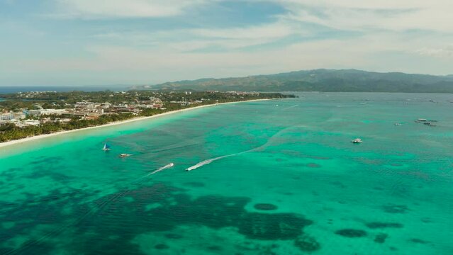 Tropical white sand beach, hotels near the blue lagoon and corall reef. aerial view, Boracay, Philippines. Seascape with beach on tropical island. Summer and travel vacation concept.