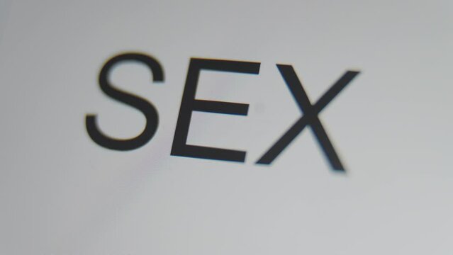 A close up of a digital screen showing a text cursor and "sex" being typed.