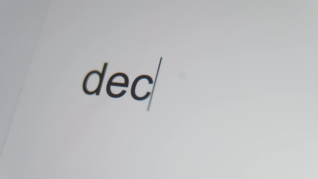 A close up of a digital screen showing a text cursor and the word "decline" being typed.