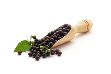 Front view of a wooden scoop filled with Fresh Organic Black nightshade or Makoy (Solanum nigrum)...